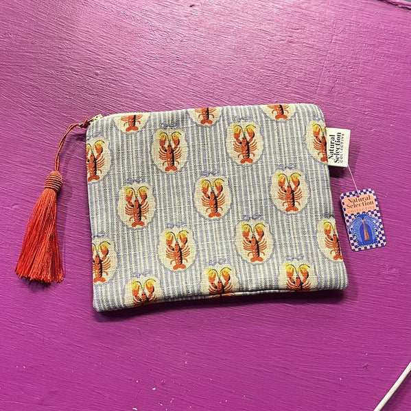 Small pouch with tassel on a purple surface